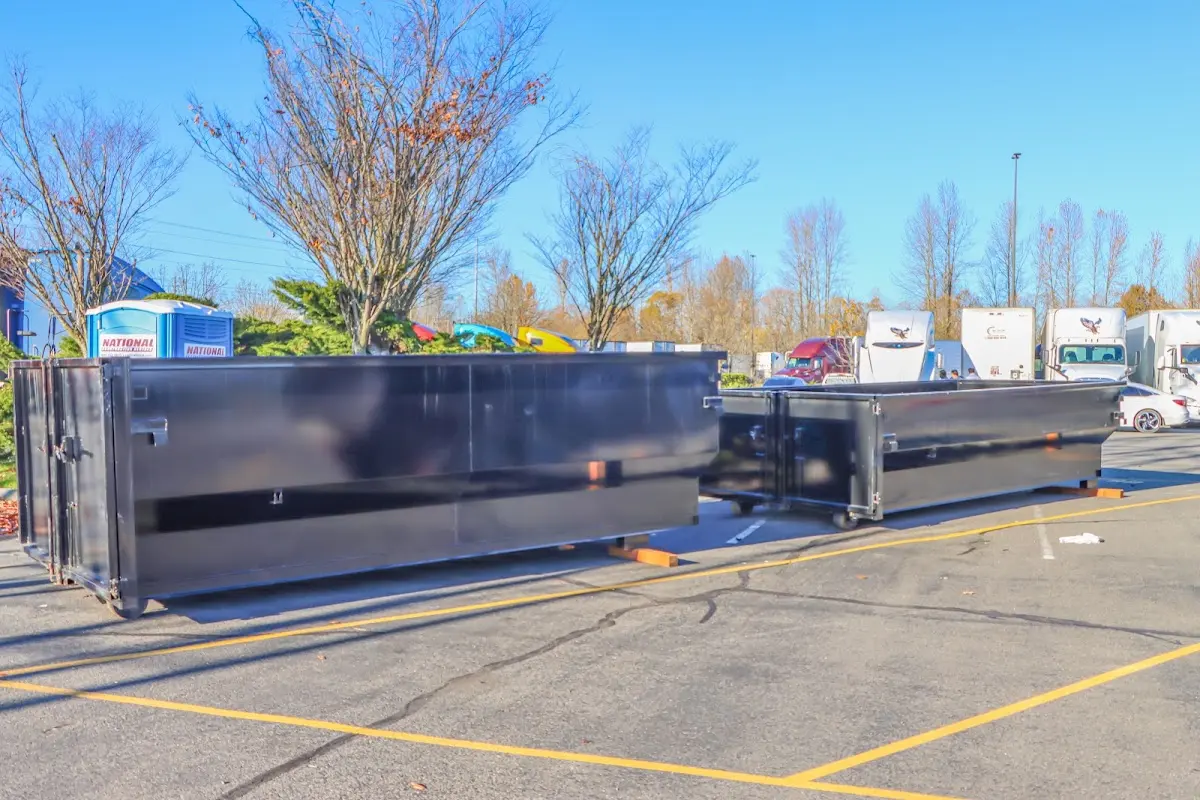 Professional dumpster rental service with roll-off container on residential driveway in Childress